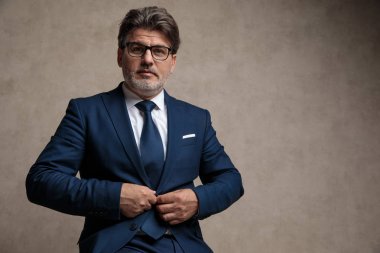 Kendine güvenen işadamı ceketinin düğmesini kapatıyor 