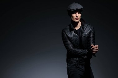 Ciddi görünümlü adam güvenle yan bakıyor 