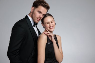 Elegant couple posing while she is laughing clipart