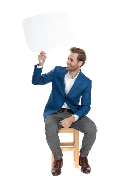 Happy casual guy holding a blank speech bubble — Stock Photo, Image
