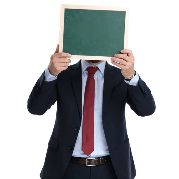 Businessman covering his face with a chalkboard — Stock Photo, Image