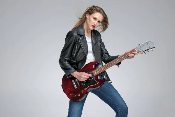 Motivated punk girl playing electric guitar — Stock Photo, Image