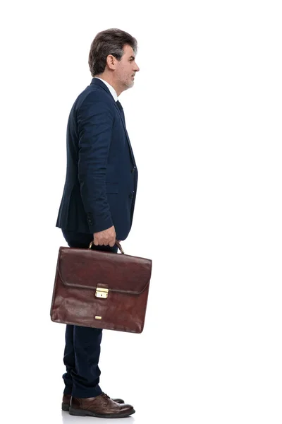 Zijaanzicht van een gemotiveerde zakenman die een aktetas vasthoudt — Stockfoto