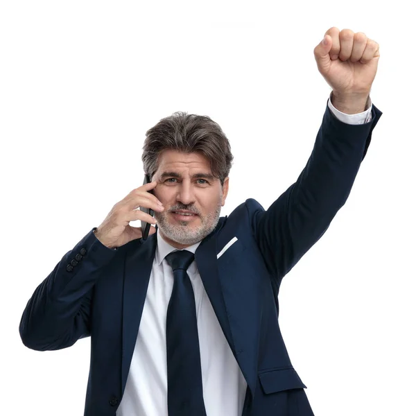 Happy businessman talking on his phone and celebrating — Stock Photo, Image