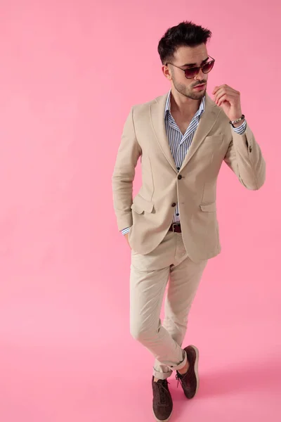 Attraktiv ung man klädd i kostym och ett par solglasögon — Stockfoto