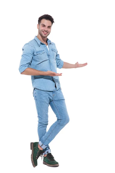 Příležitostný mladý muž s džísim a prezentuje se na straně — Stock fotografie