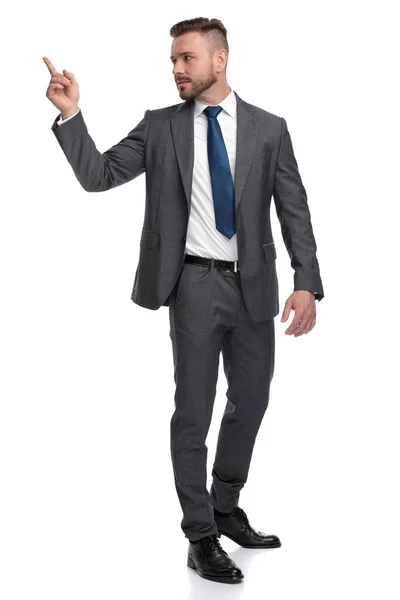 Young business man pointing finger at his back — Stock Photo, Image