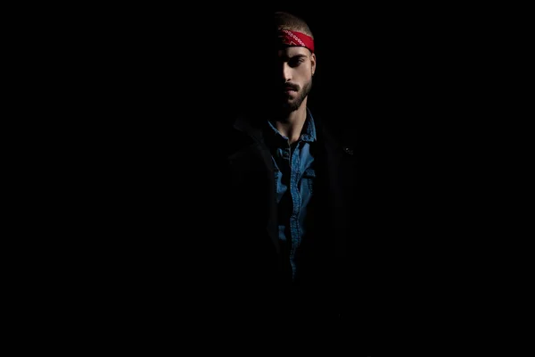 Attractive young man wearing a bandana on black background — Stock Photo, Image