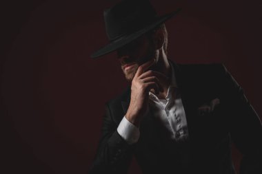 smokin ve siyah şapka giyen çekici genç adam