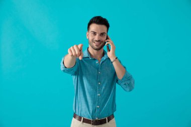 adam telefonda konuşuyor ve ileri işaret