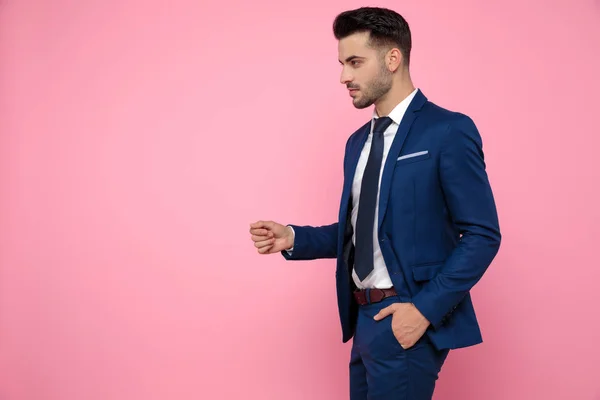 confident casual man wearing blue suit and looking to side