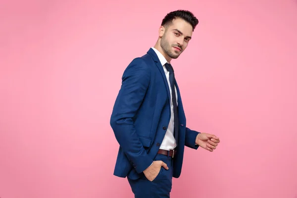 Side view of attractive young man in navy blue suit — Stock Photo, Image