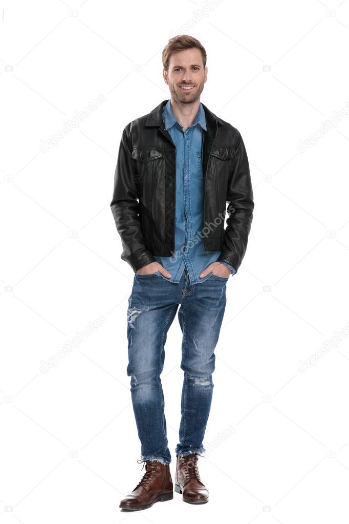 man standing with hands in pockets