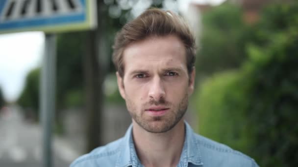 Young Man Serious Face Walking Outdoor Closeup Shot — Stock Video