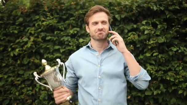 Podekscytowany Młody Dorywczo Człowiek Przechwala Jego Wielką Wygraną Telefon — Wideo stockowe
