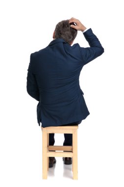 businessman sitting in face of a problem clipart