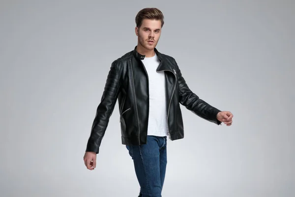 Casual man with black leather jacket walking relaxed — Stock Photo, Image