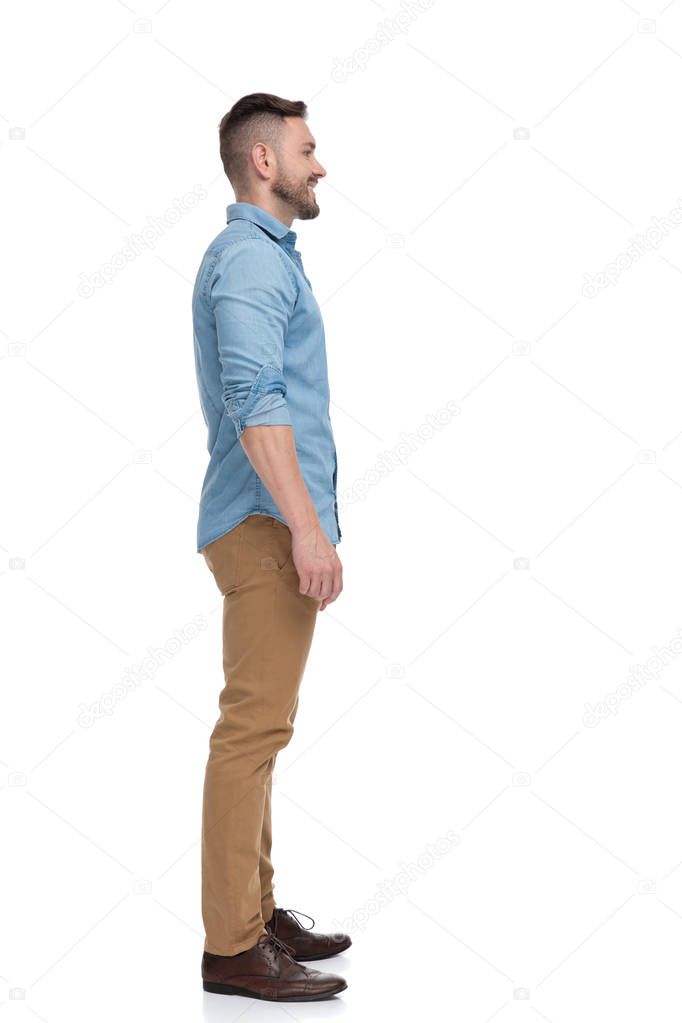 casual man waiting in line looking ahead