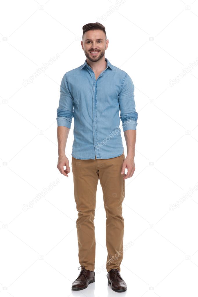 casual man standing and looking ahead happy