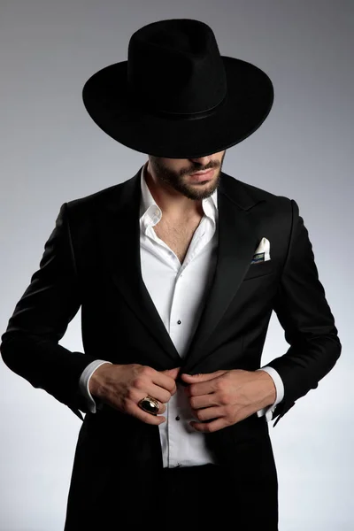 Mysterious young model wearing tuxedo and black hat — Stock Photo, Image