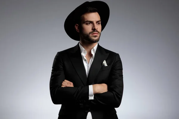 Elegant young model wearing tuxedo and black hat — Stock Photo, Image