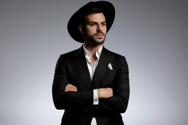 elegant young model wearing tuxedo and black hat