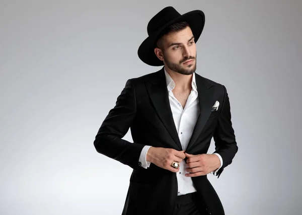 Attractive young man wearing black tuxedo and hat — Stock Photo, Image