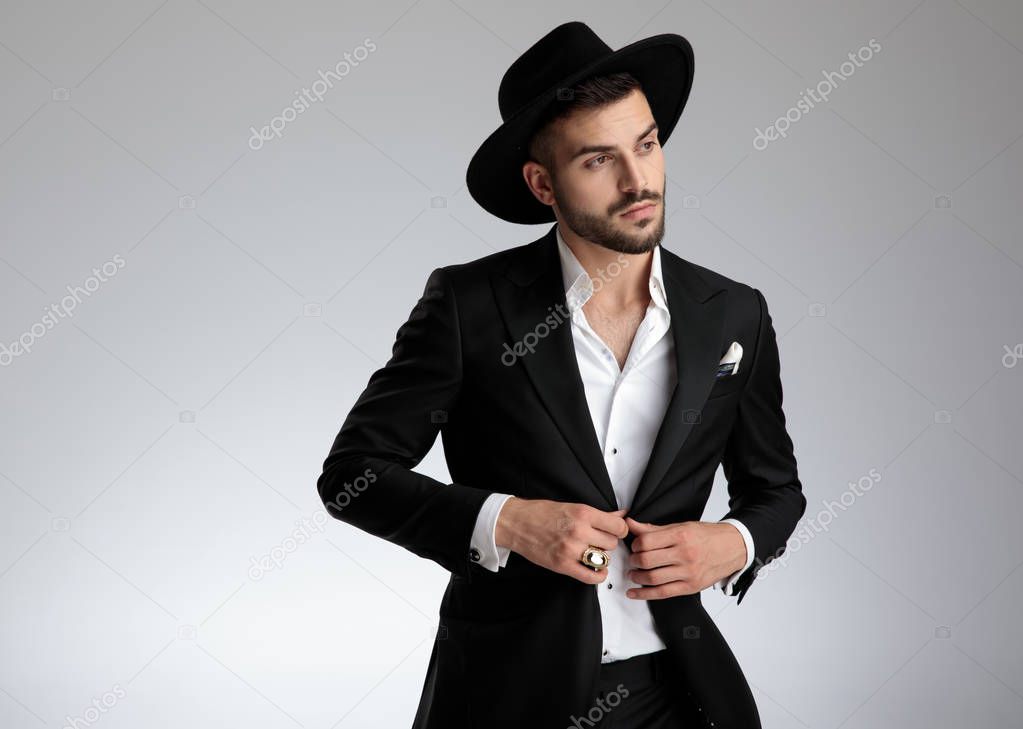 attractive young man wearing black tuxedo and hat