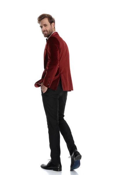 Fashion model walking and wearing red velvet tuxedo — Stock Photo, Image