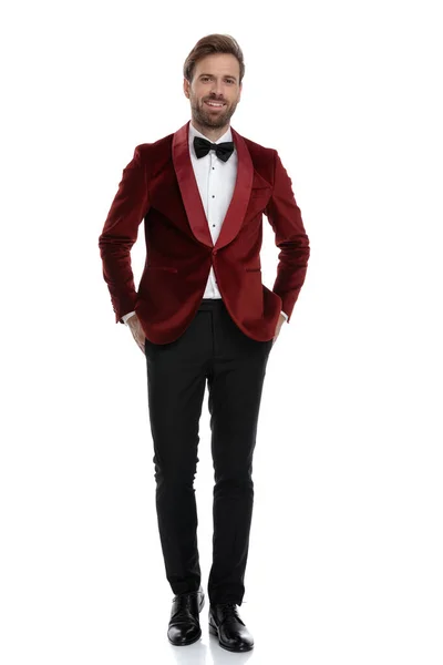 Happy young fashion model smiling and wearing red velvet tuxedo — Stock Photo, Image