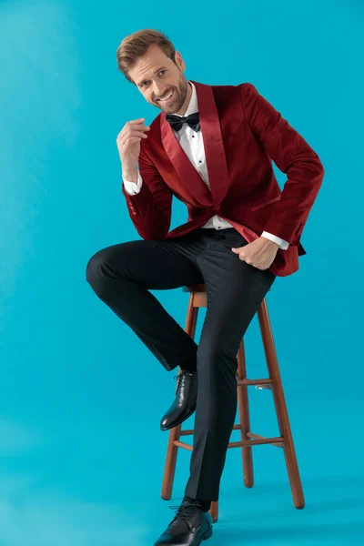 Heureux élégant homme souriant et portant smoking en velours rouge — Photo