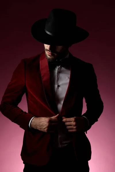 Young fashion model wearing red velvet tuxedo and hat — Stock Photo, Image