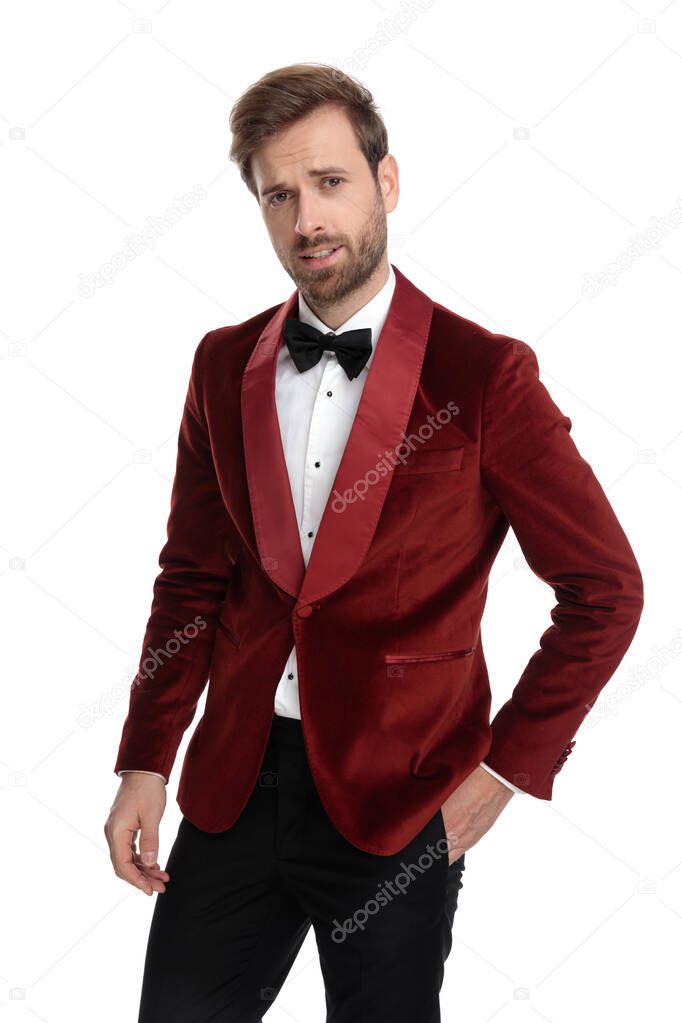 confused fashion model wearing red velvet tuxedo