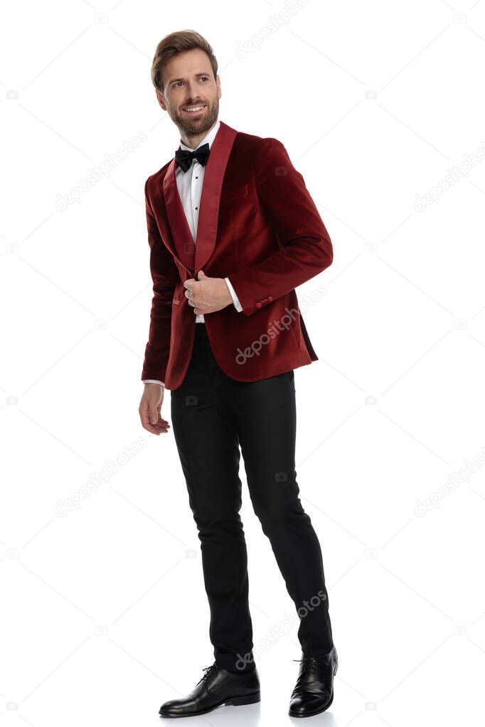 fashion model wearing red velvet tuxedo and smiling