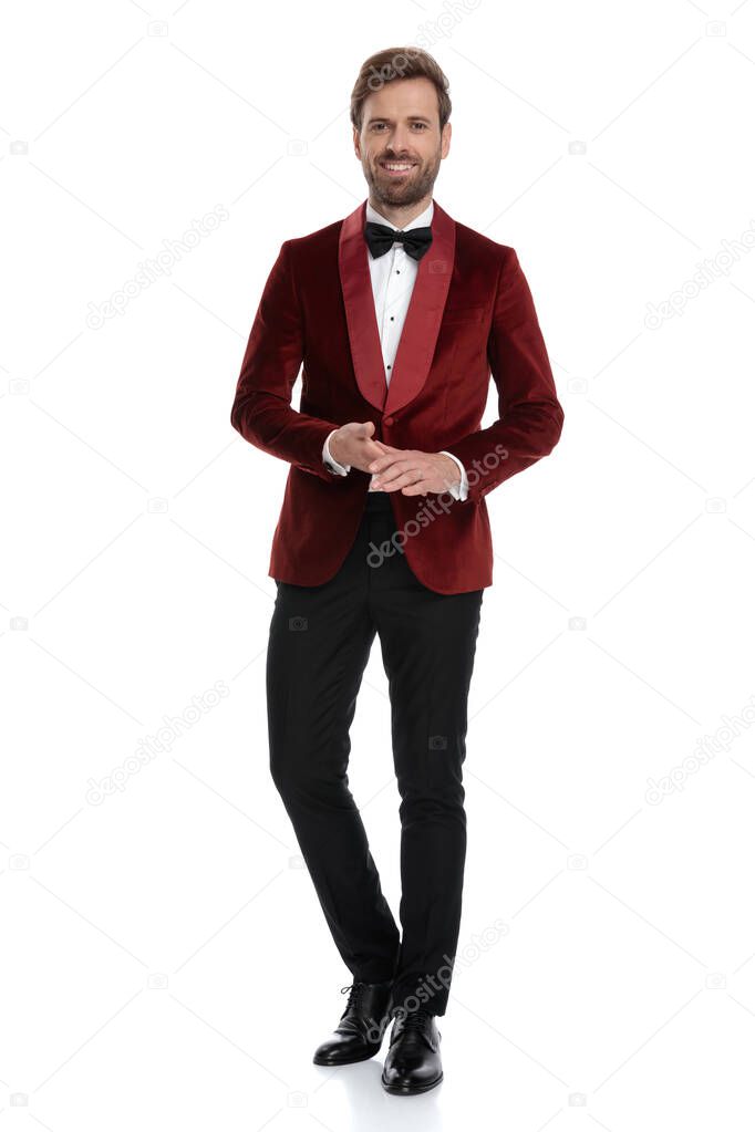 happy young man wearing red velvet tuxedo and black bowtie