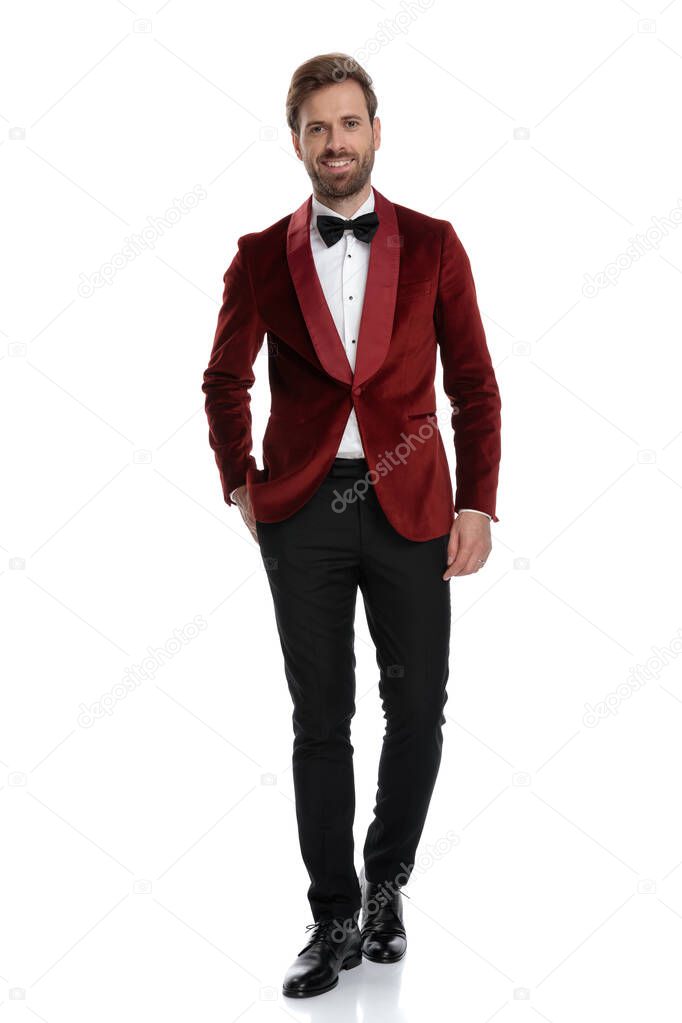 smiling young groom wearing red velvet tuxedo 