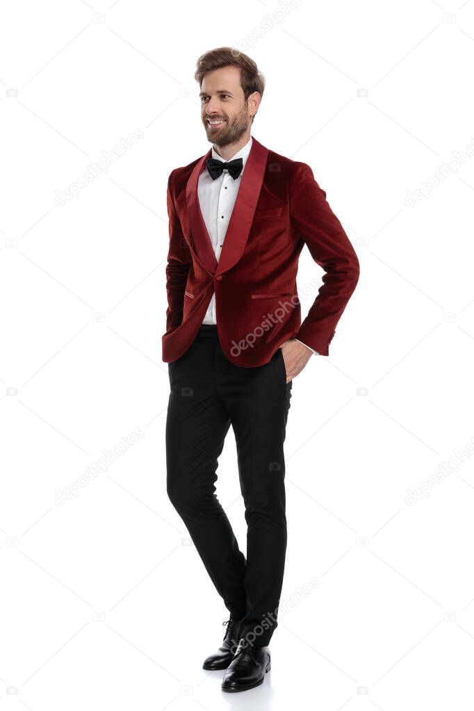 happy young fashion model smiling and wearing red velvet tuxedo