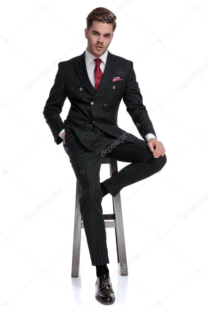 elegant young fashion model wearing double breasted suit and red