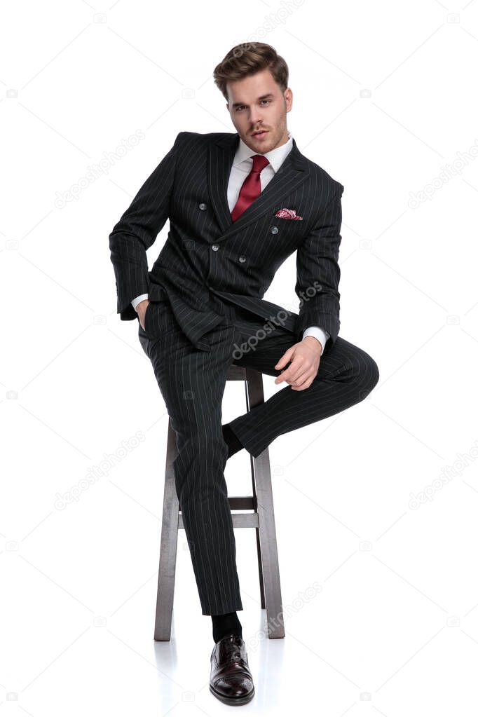 elegant fashion man wearing double breasted suit and red tie