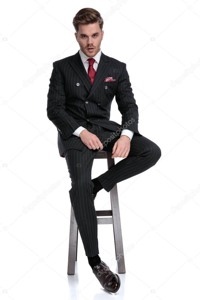 young modern businessman wearing double breasted suit and red ti