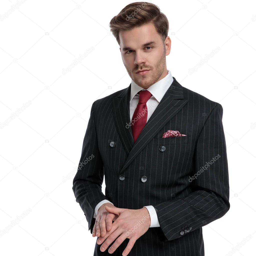 elegant young businessman wearing double breasted suit and red t