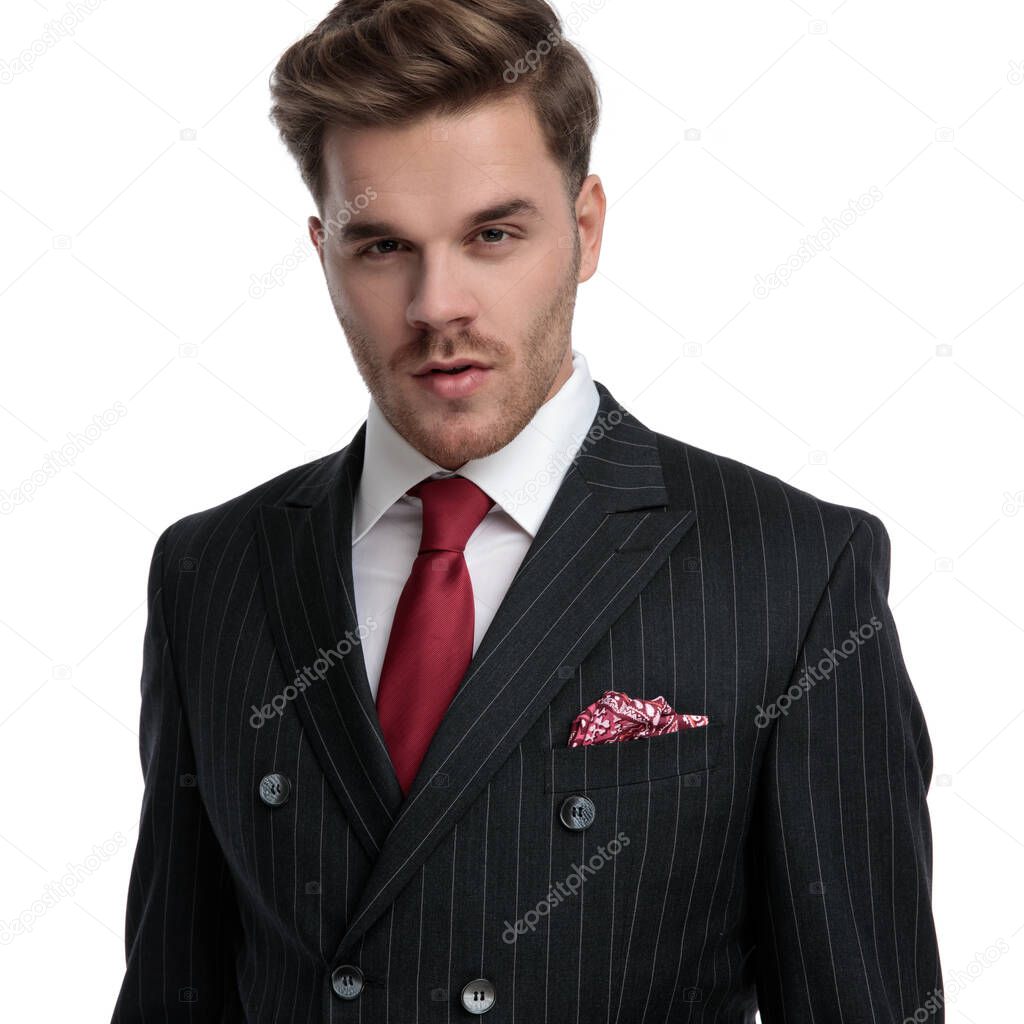 elegant young businessman wearing double breasted suit and red t