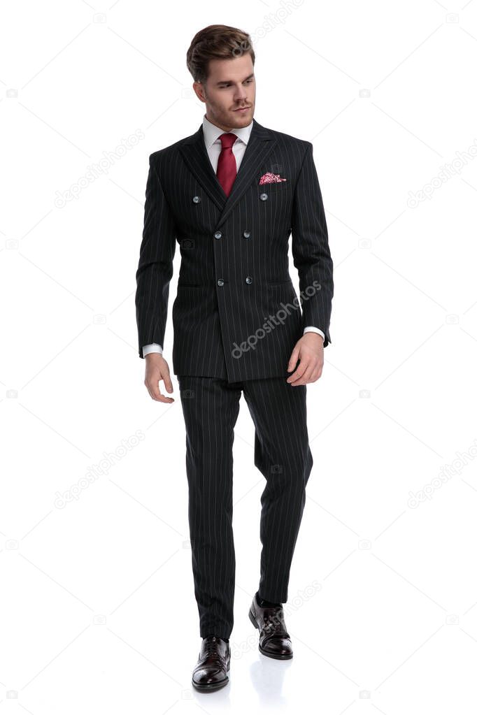 confident young businessman wearing double breasted suit and red