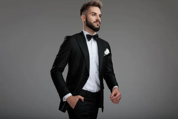 Motivated groom walking and holding a hand in his pocket — Stock Photo, Image