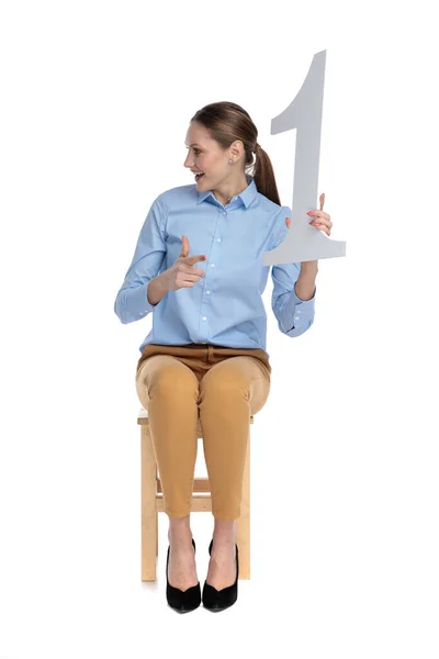 Happy young businesswoman showing number one sign — Stock Photo, Image