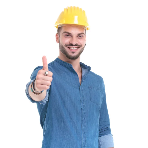 Positive casual man giving and thumbs up and smiling — Stock Photo, Image