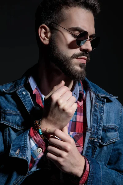 Close up of a wondering casual man adjusting his bracelets — Stock Photo, Image