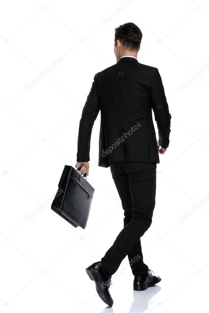Rear view of a convinced businessman holding a briefcase