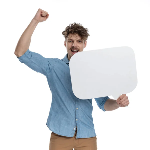 Enthusiastic Guy Holding Speech Bubble Holding Arms Celebrating Victory Standing — Stock Photo, Image