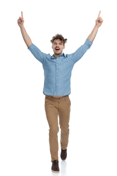 Enthusiastic Casual Man Pointing Fingers Air Celebrating Victory Walking Isolated — Stock Photo, Image
